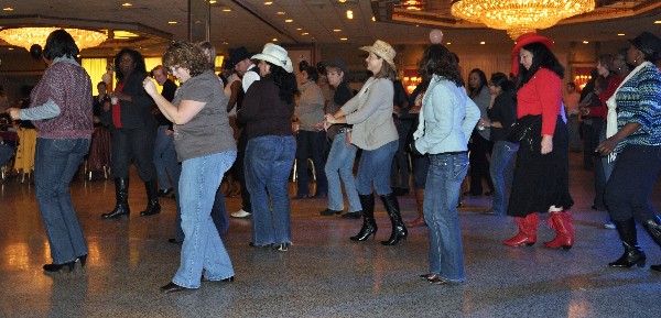 At the November fundraiser, chapter members, guests and volunteers enjoy a little line dancing.